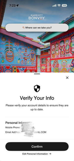 Mobile screen displaying a verification prompt for account details over a colorful mural background.